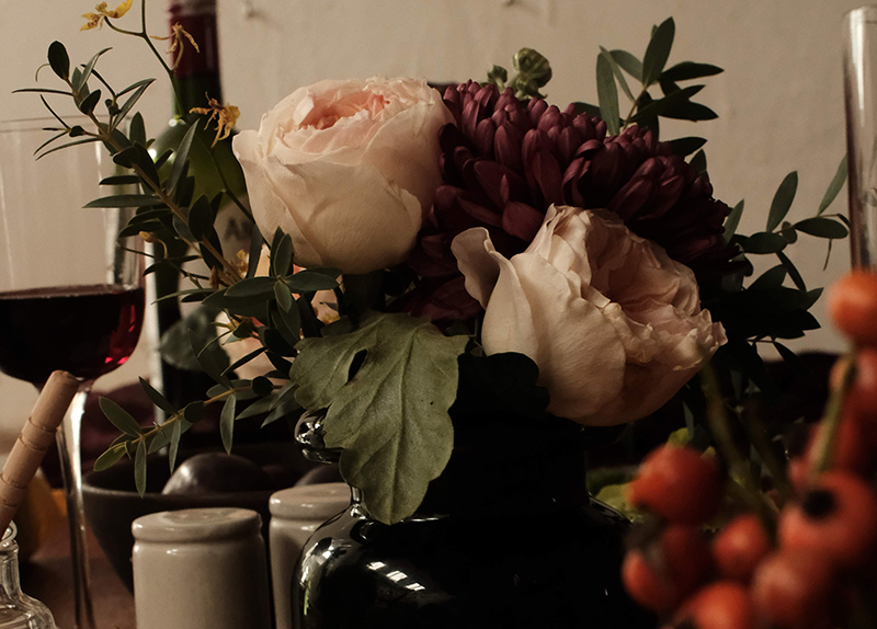 a bouquet of flowers, mostly light pink roses placed on a table