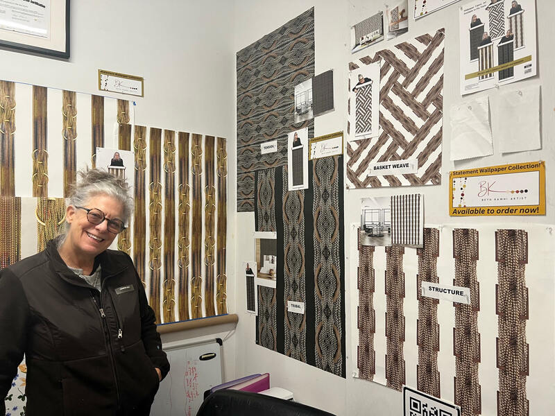Beth Kamhi pictured in front of her upcoming Wallpaper and Fabric Collection. 